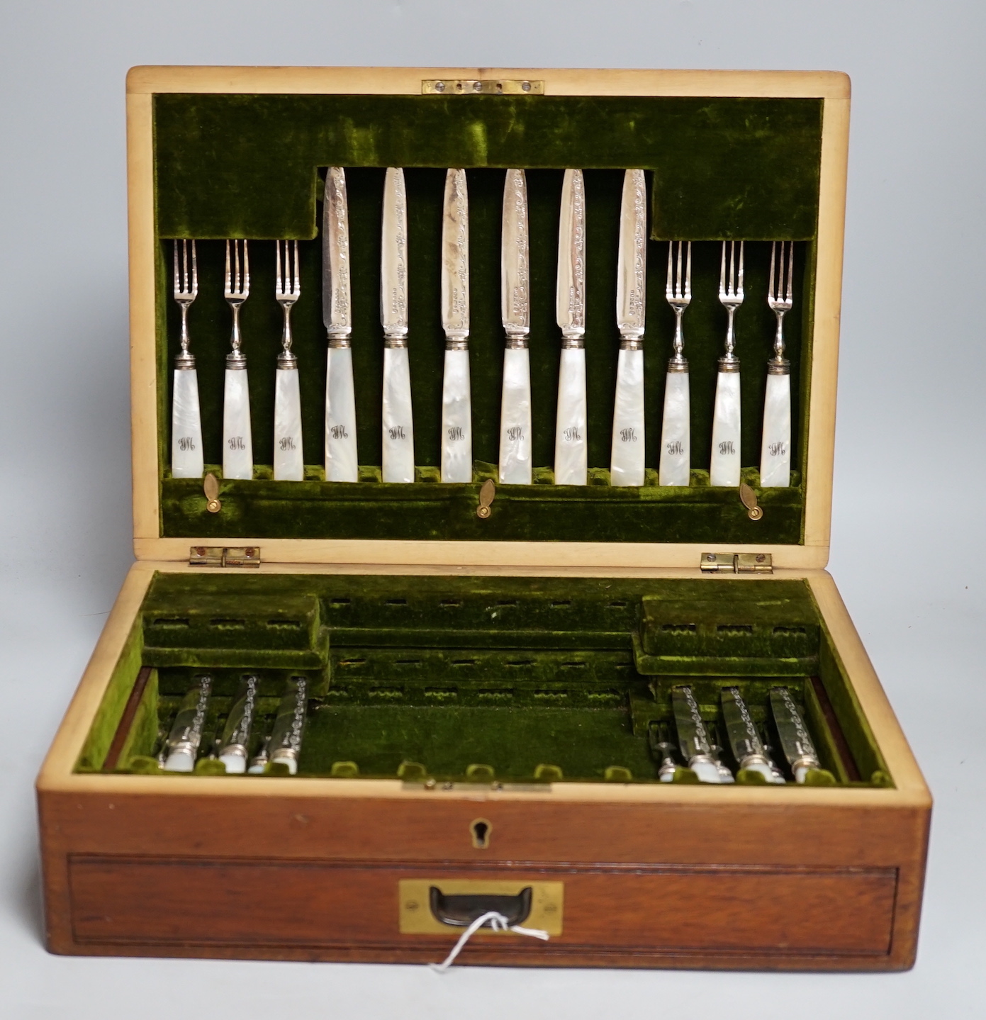 A mahogany case of plated cutlery and part set of mother of pearl handled dessert knives and forks, largest 46cm wide